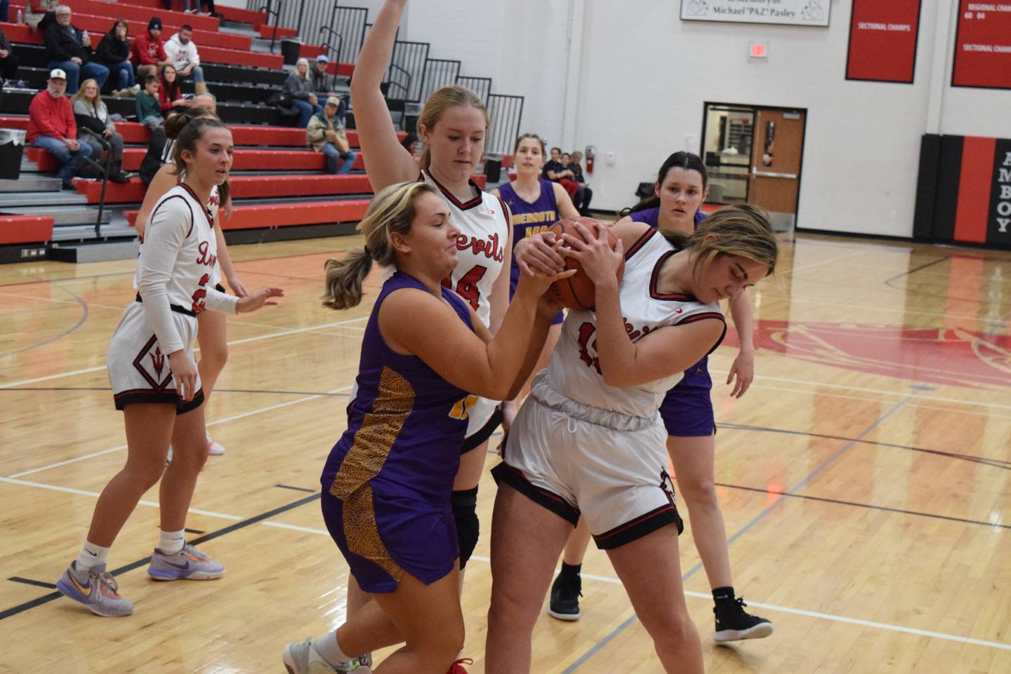 Mendota's Ryleigh Sondgeroth (left) and Hall's McKenna Christiansen battle for the  ball in the third-place game of the Amboy Holiday Tournament on Friday, Hall won 62-31.
