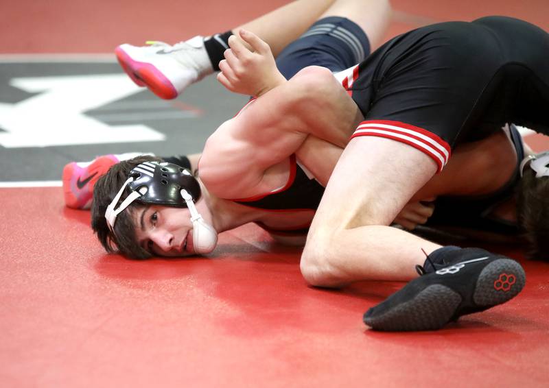 Yorkville’s Josh Stockl (bottom) battles Oswego East’s Darek Speice in the 144-pound weight class during a dual meet on Thursday, Jan. 9, 2025 in Yorkville.