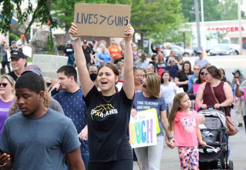 Protesters chant as they return to Hopkins Park in DeKalb after marching down the sidewalk of Sycamore Road Saturday, June 11, 2022, during a March For Our Lives event. The March For Our Lives initiative advocates for, among other things, an end to gun violence, updated gun control legislation and policy targeting gun lobbyists.