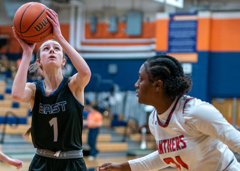 Oswego East's Aubrey Lamberti (1) shoots the ball in the post against Oswego’s Kendall Fulton (21) during a basketball game at Oswego High School on Tuesday, Feb 7, 2023.