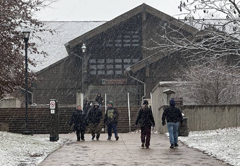 Snow falls to the ground outside the Starved Rock Visitors Center as hikers visit on Thursday, Jan. 2, 2025 at Starved Rock State Park.
