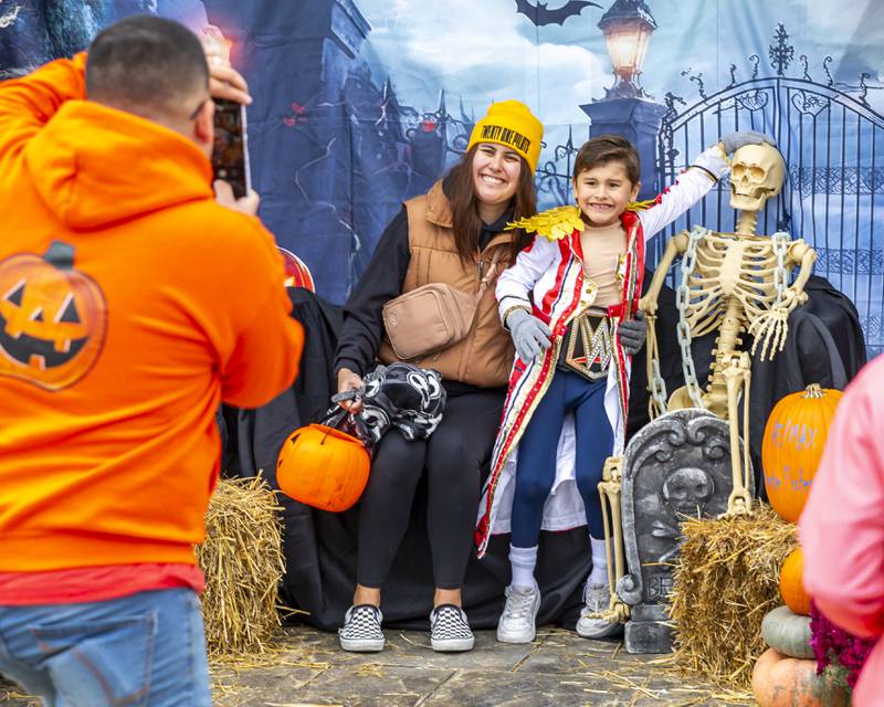 Maria Tijerin poses with her son Luke for a picture taken by Jose Mendez with Remax at the Plainfield Spooktacular Trick-or-treating event Saturday Oct 25, 2025 in Plainfield.