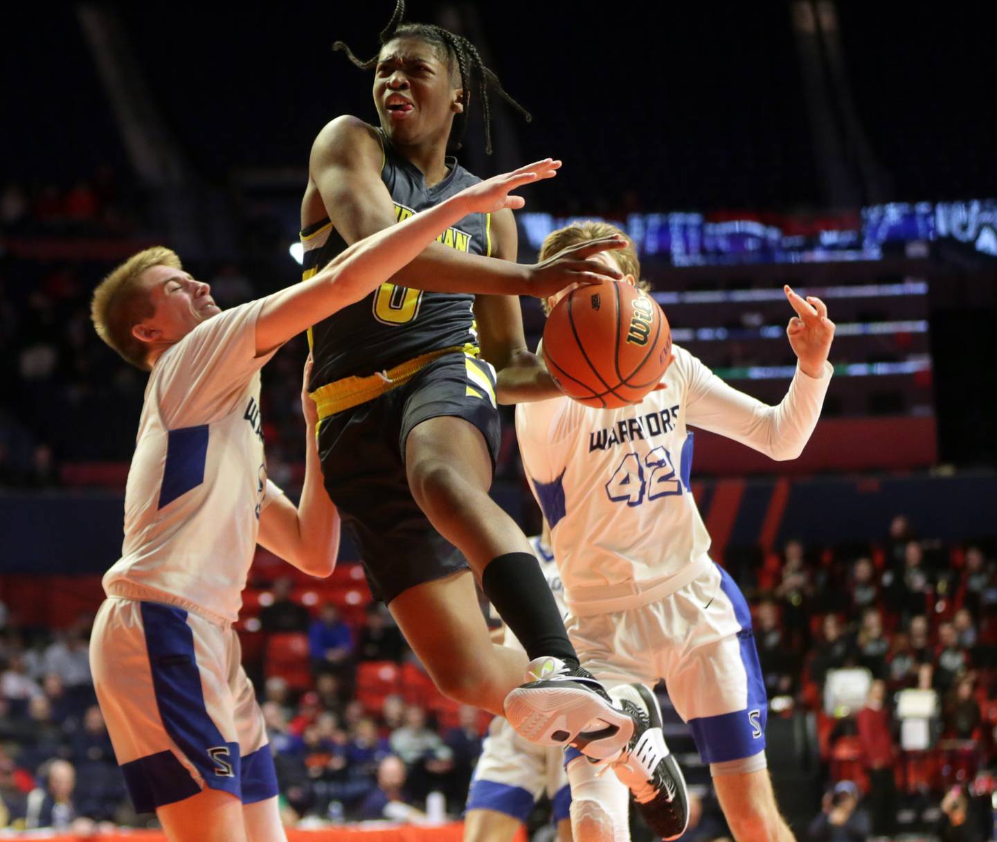 Yorkville Christian's K.J. Vasser (0) leaps in the lane to score as Steeleville's Lane Lazenby (2) and Reid Harriss (42) defend in the Class 1A State semifinal game on Thursday, March 10, 2022 at the State Farm Center in Champaign.