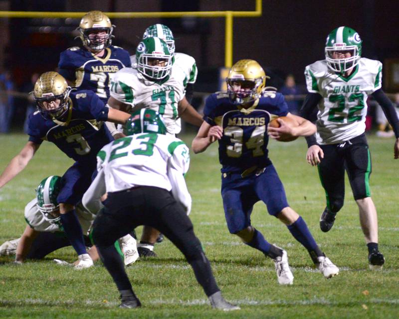 Polo's Gage Zeigler (34) looks for a gap as he runs with the ball against Alden-Hebron during 8-man playoff action on Friday, Nov. 1, 2024 in Polo.