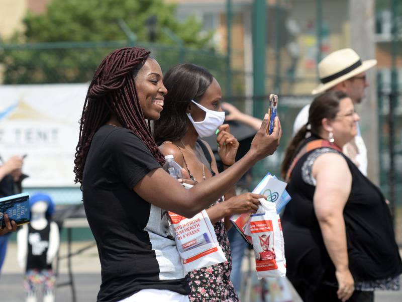 People including Katrina Grady of Orland Park enjoy listening to Microphone Misfits  during the Juneteenth event in Berwyn held Saturday June 19, 2021.