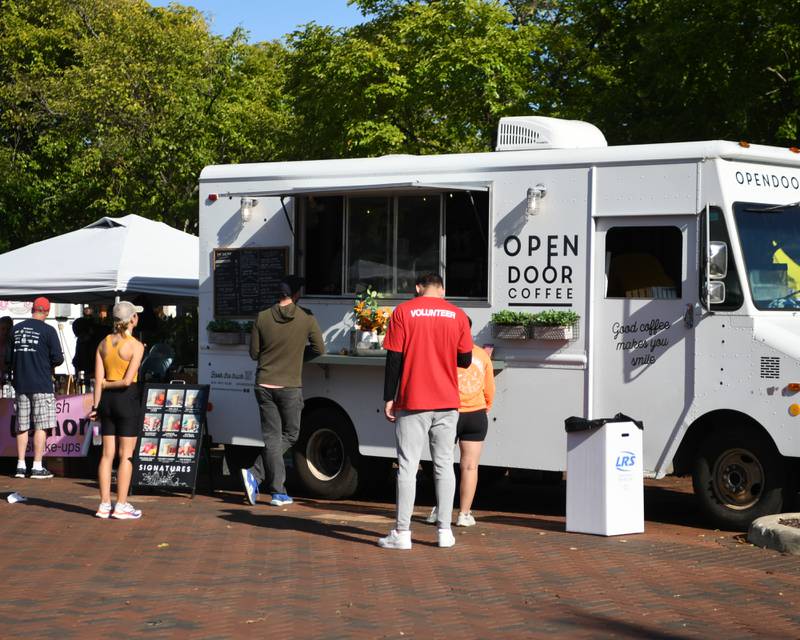 Participants enjoy food and drinks from Genoa's OpenDoor Coffee truck during the annual Taste of DeKalb after finishing the DeKalb Corn Classic 5K/10k races on Sunday, Sept. 29, 2024, downtown.