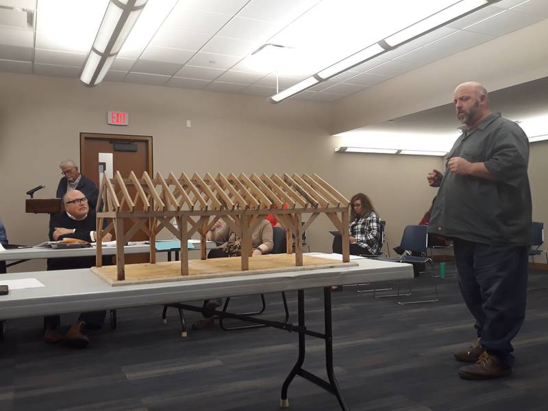 Streator High School vocational instructor David Taylor (right) shows the Streator City Council a model of the proposed picnic pavilion for Marilla Park during its Tuesday, April 12, 2022, meeting at City Hall.