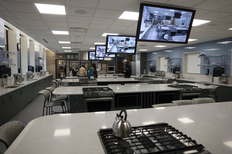 Guest tour one of the two state-of-the-art culinary labs that can accommodate 32 students at the ribbon cutting ceremony for Joliet Central’s new culinary arts addition on Monday, Jan. 6, 2025 in Joliet.