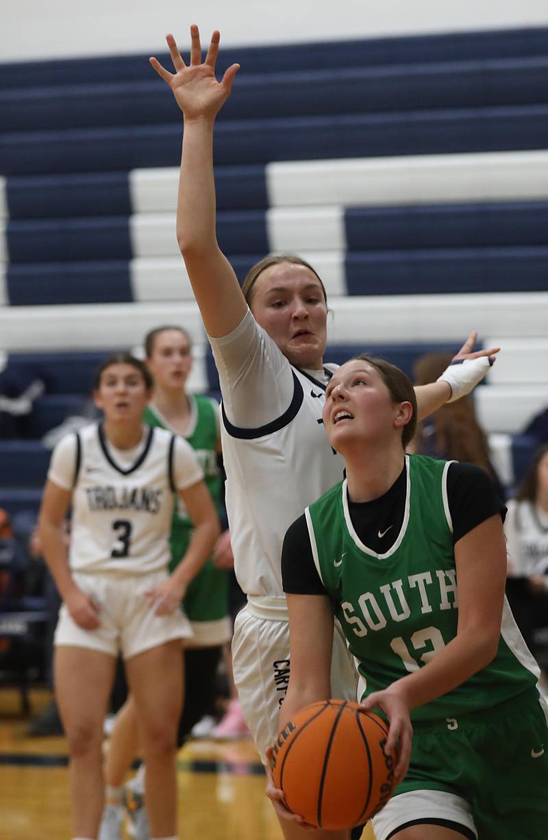 Crystal Lake South's Gaby Dzik drives to the basket against Cary-Grove's Isabella Limburg during a Fox Valley Conference girls basketball game on Tuesday, Dec. 2, 2025, at Cary-Grove High School in Cary.