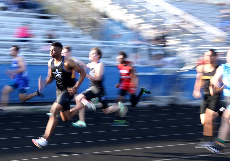 St. Charles North’s Joshua Duncan competes in the 100-meter dash during the Kane County Boys Track and Field Invitational at Geneva High School on Monday, May 9, 2022.