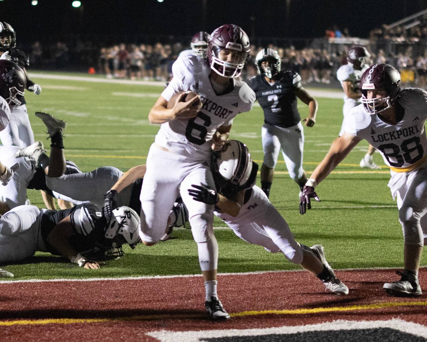 Lockport quarterback Drew Gallagher scores against Plainfield North on Friday, Aug. 25, 2023 in Plainfield.