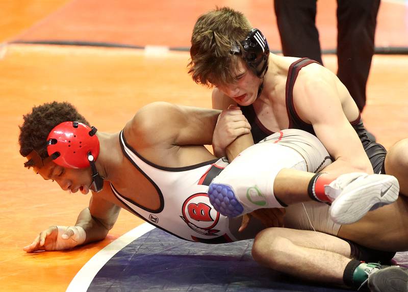 Prairie Ridge’s Tyler Evans controls Bremens’ Nore Turner during the Class 2A 120 pound 3rd place match in the IHSA individual state wrestling finals in the State Farm Center at the University of Illinois in Champaign.