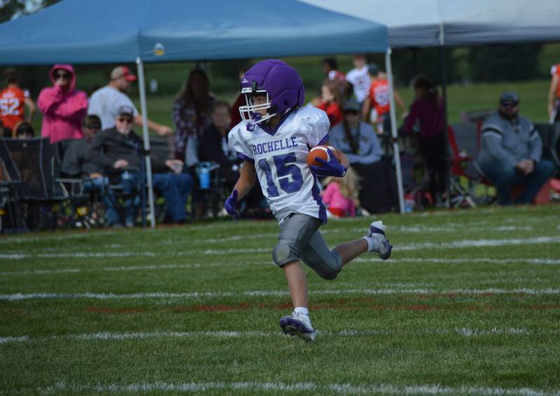 Rochelle's Noah Hayden breaks through a host of defenders and scores a 30-yard touchdown during a seventh-grade junior tackle football game with Stillman Valley on Sunday, Sept. 7, 2025. Rochelle won the game 20-6.