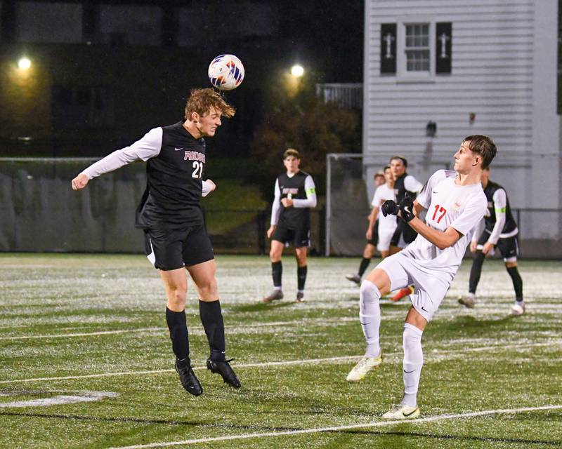 Prairie Ridge's Nicolas Flaugher (21) heads the ball while being defened by Benet Academy's Brendan Bergnach (21) during the class 2A super sectional soccer match on Tuesday Nov. 5, 2024, held at Wheaton Academy in West Chicago.