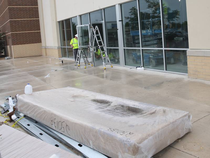 Crews install the front doors to the new Five Below store on Tuesday, July 8, 2025 between Kohl's and PetSmart in Peru. The 10,083 square foot building is starting to take shape. Five Below is a chain of specialty discount stores that prices most of its products at $5 or less with a smaller assortment of products priced up to $25.