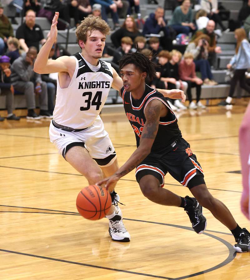 DeKalb's Darrell Island drives around Kaneland's Parker Violett during their game Tuesday, Jan. 24, 2023, at Kaneland High School.