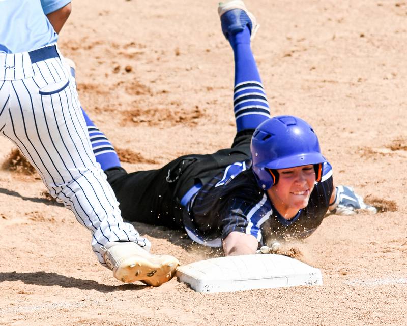 Newman's Daniel Kelly (2) dives back to first on a pick-off move Monday morning at the supersectional against Marquette.