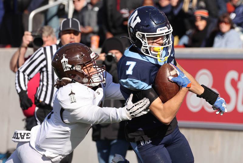 Nazareth's Jake Cestone outruns Joliet Catholic's Tai Sesta to the endzone after a catch Saturday, Nov. 25, 2023, during their IHSA Class 5A state championship game in Hancock Stadium at Illinois State University in Normal.