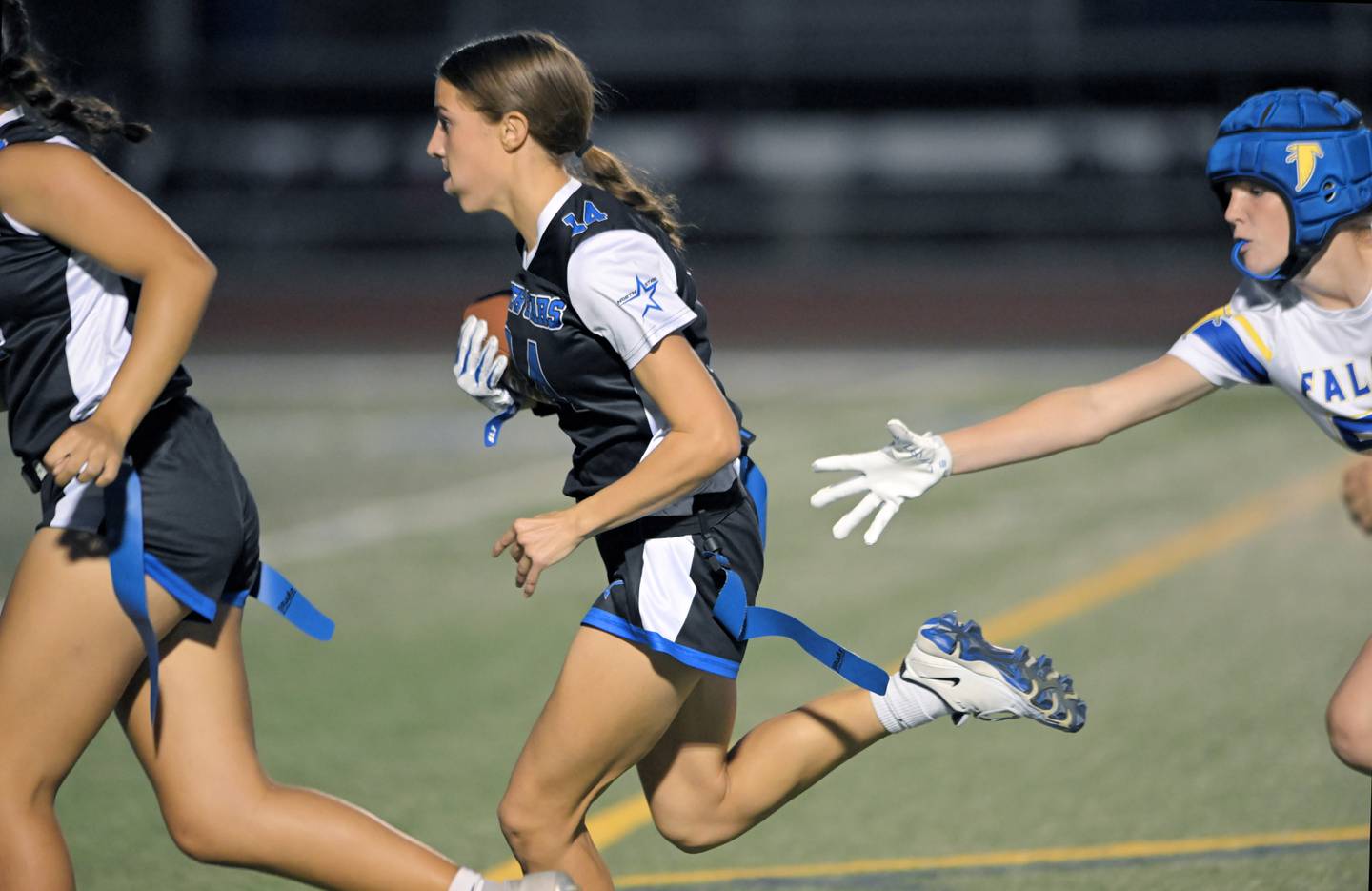St. Charles North’s Kaelie Tomalak outruns Wheaton North’s Emily Bruzdzinski in a girls flag football game in St. Charles on Monday, Sept. 15, 2025.