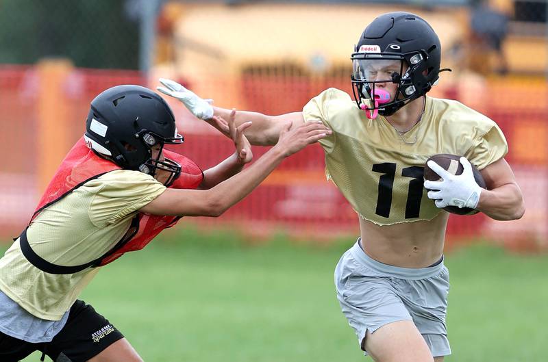 Sycamore's Burke Gautcher carries the ball Monday, Aug. 8, 2022, at the school during their first practice ahead of the upcoming season.