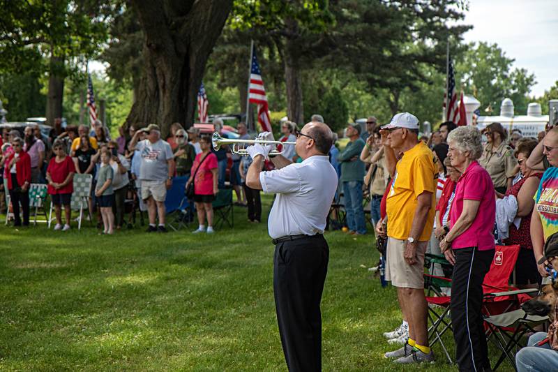 Chris Hammit plays Taps at the Oakwood cemetery on Memorial Day, May 29, 2023.