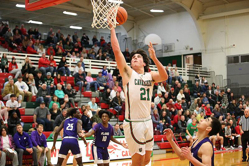 L-P's Josh Senica (21) runs in for a layup past Plano's Eric Cano (11) on Friday Dec. 2, 2022 in Sellett Gymnasium at La Salle-Peru Township High School.