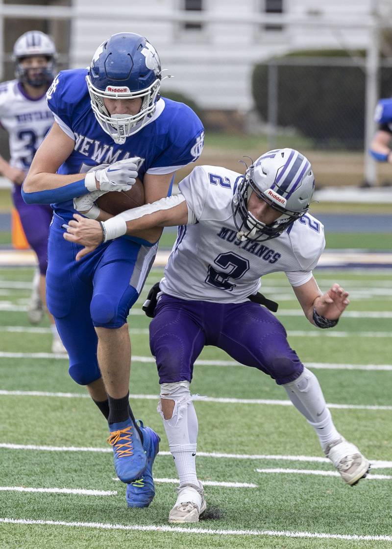 Newman’s John Rowzee keeps his feet against Ridgeview-Lexington’s Blaine Friendmansky Saturday, Nov. 1, 2025, in round one of the Class 2A football playoffs.