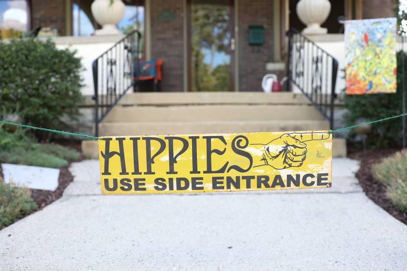 A sign directs music lovers to enter through the back for the music performance at a home on Wilcox Street. The Upper Bluff Historic District hosted Porch & Park Music Fest featuring a variety of musical artist at five different locations. Saturday, July 30, 2022 in Joliet.