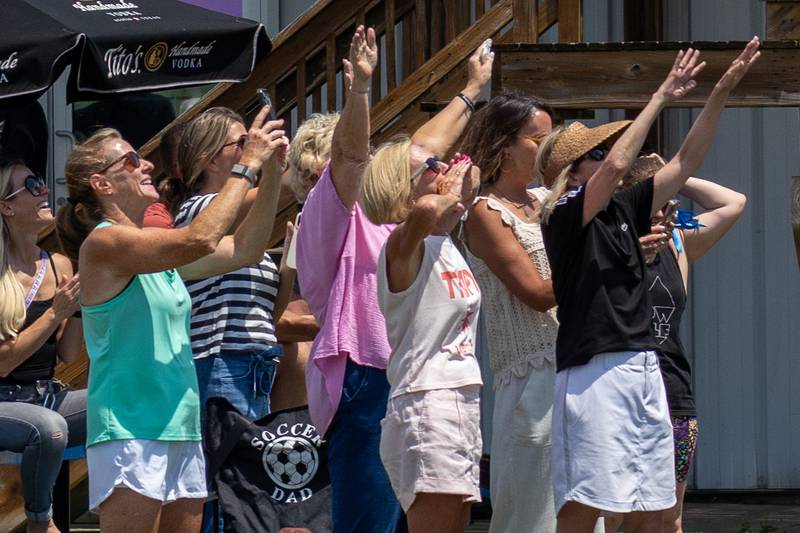 Friends and family cheer on Kathy Traegar as she skydives for charity on Friday, July 11, 2025 at Skydive Chicago in Ottawa.