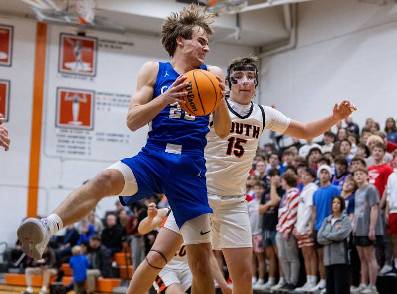 Geneva’s Jack Hatton recovers a layup during an away game against Wheaton Warrenville South High School on Tuesday, Dec. 3, 2024.