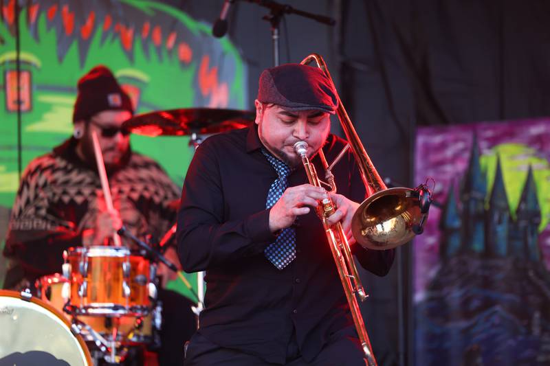 Allen Hernandez plays horns with the band Tone Zone Skam at Panic at the Plaza on Saturday, Oct. 7, 2023 in Joliet.