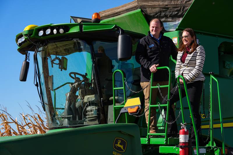 U.S. Secretary of Agriculture Brooke L. Rollins, right, films a social media post on a combine with farm owner Tyler Everett during a farm tour in Lebanon, Ind., Thursday, Oct. 30, 2025. (AP Photo/Michael Conroy)