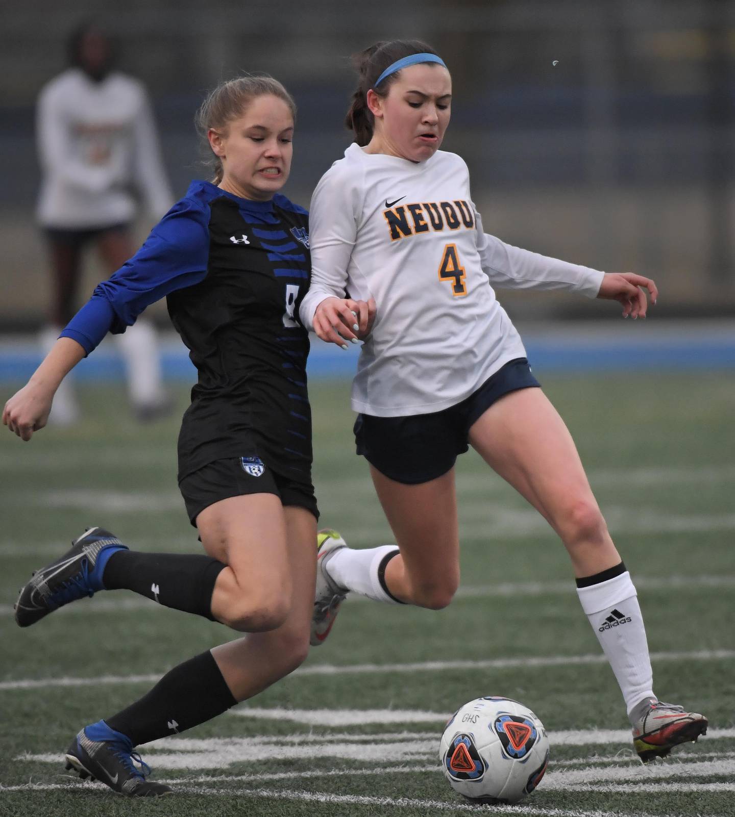 Geneva’s Olivia Hagen battles with Neuqua Valley’s Allessandra Russo who loses a fingernail, upper right, in the competition in a girls soccer game in Geneva on Thursday, March 23, 2023.