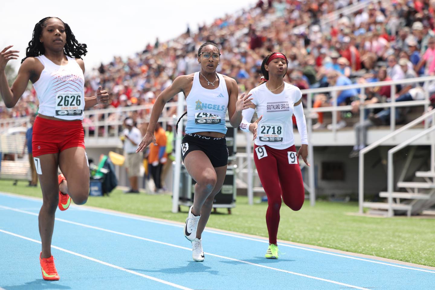 Joliet Catholic’s Symone Holman, center, finishes in third place in the 100 m dash during the IHSA Class 2A Girls Track & Field State Finals on Saturday, May 24, 2025.