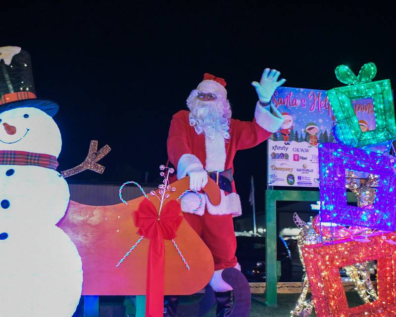 Santa waves to community members that came out to watch the parade and tree lighting ceremony on Friday Nov. 21, 2025, held at Riverfront Park in Yorkville.