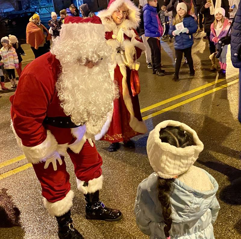 Santa Claus greets children along State Street in downtown Sycamore for Discover Sycamore's annual Walk with Santa on Friday, Dec. 1, 2023.