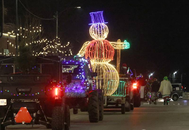 A large light up snowman rides during the "Night of Lights" parade on Friday, Dec. 5, 2025 downtown Princeton. The event featured the Christmas tree lighting at Veterans Park a lighted Christmas parade down Main Street,  Living Windows, a Candy Cane Hunt, and visits with Santa.