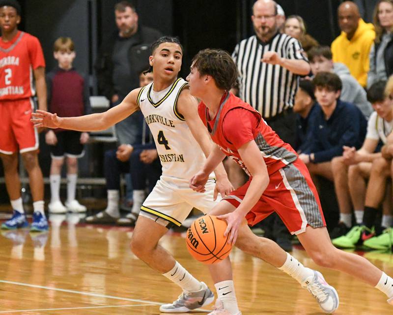 Yorkville Christian's Tray Alford (4) plays defenses against Aurora Christian's Jacob Baumann (22) during the game on Friday Feb. 28, 2025, held at Indian Creek High School.
