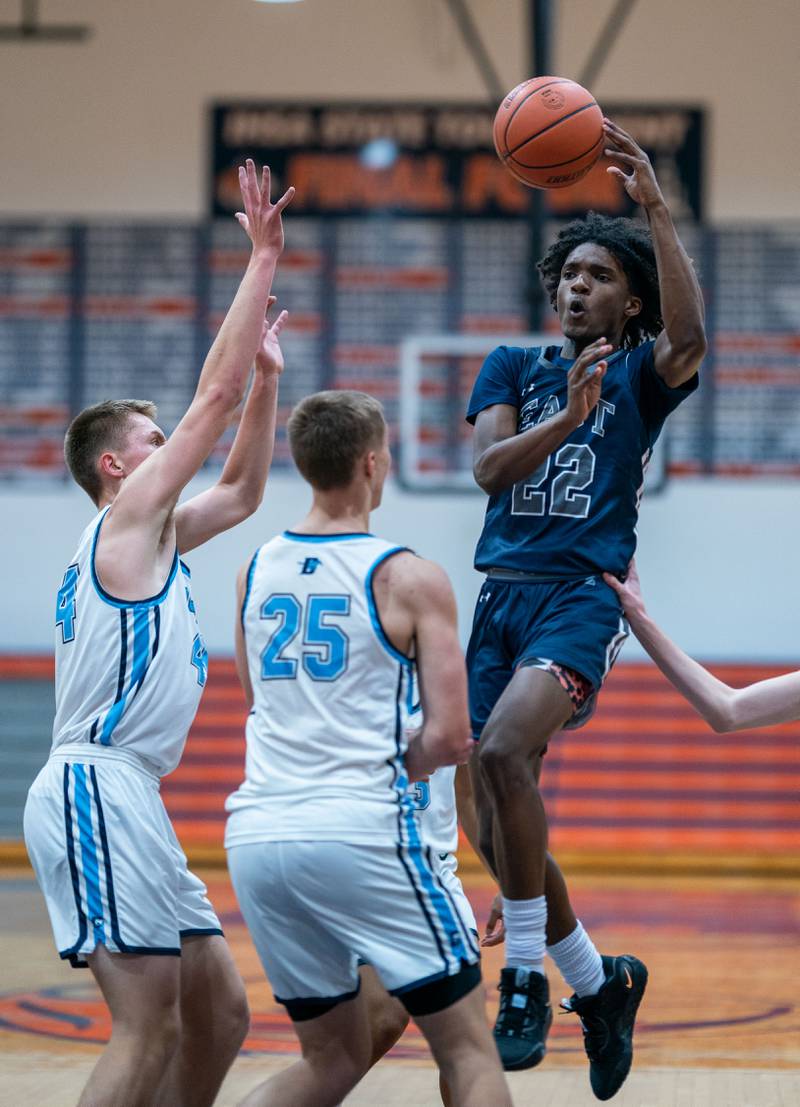 Oswego East's Jehvion Starwood (22) throws a no look pass against Downers Grove South during the hoops for healing basketball tournament at Naperville North High School on Monday, Nov 21, 2022.