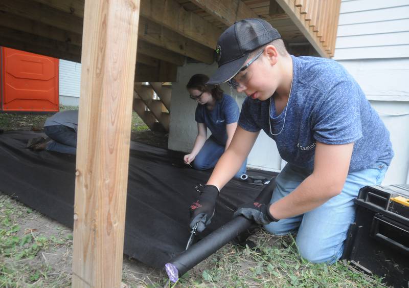 Ashlin Jackson (left), 16, of Marseilles, and Ryker Terry, 14, of Seneca, landscape as they volunteer for Labor of Love at a home on 1100 block of Washington Street in Marseilles on Saturday, Oct. 2, 2021.
