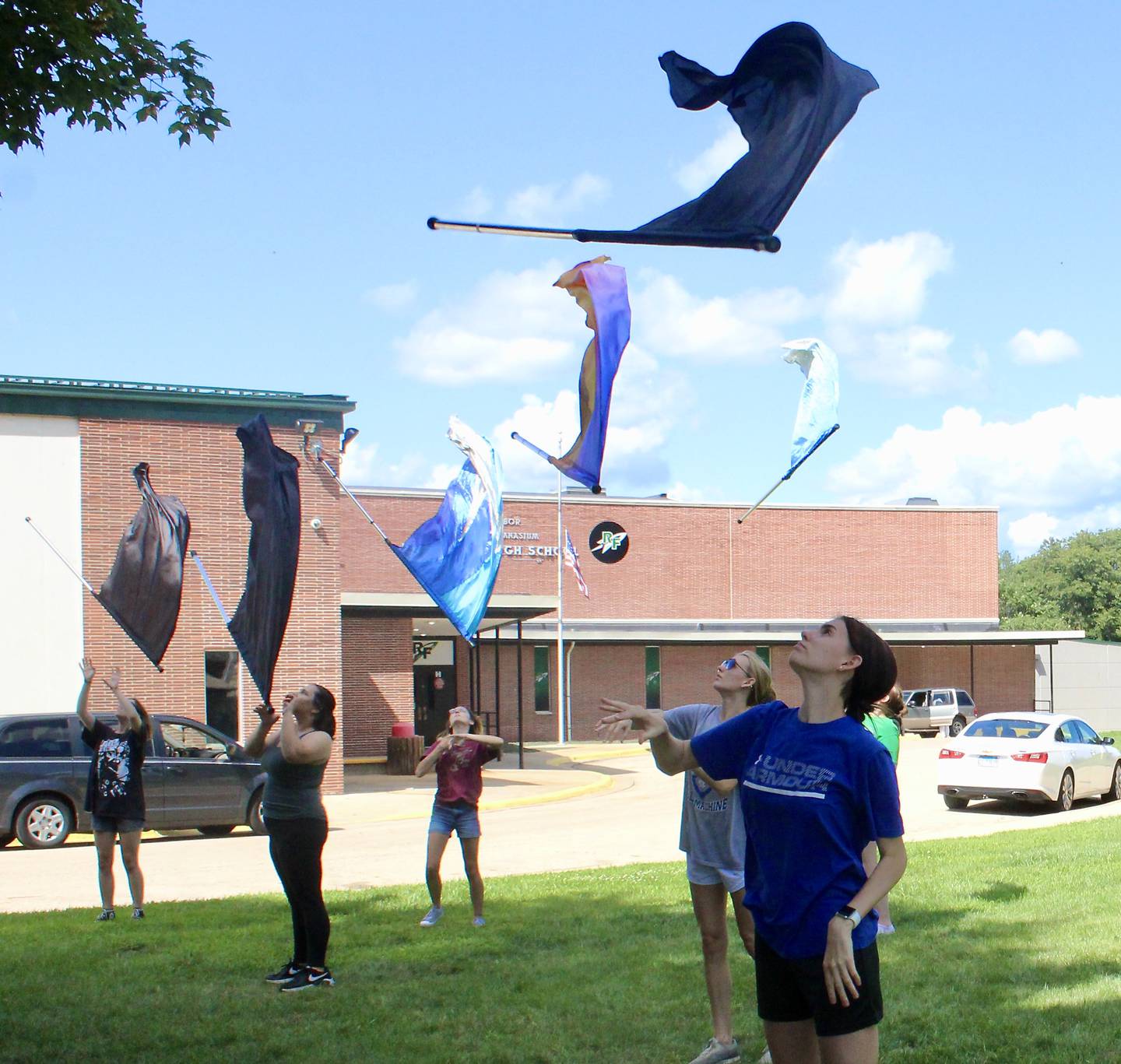 Members of the Rock Falls High School color guard take part in drills on the campus lawn on Friday. The first day of class is Aug. 18.