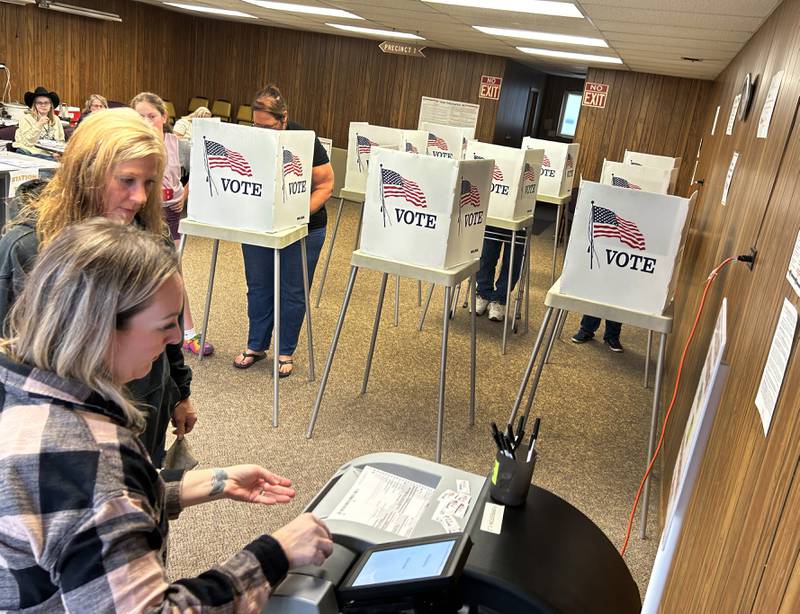 Dana Josephitis watches as Election Judge Elsie DeVries helps her tally her ballot at the Forreston Township Building on Tuesday, Nov. 5, 2024.