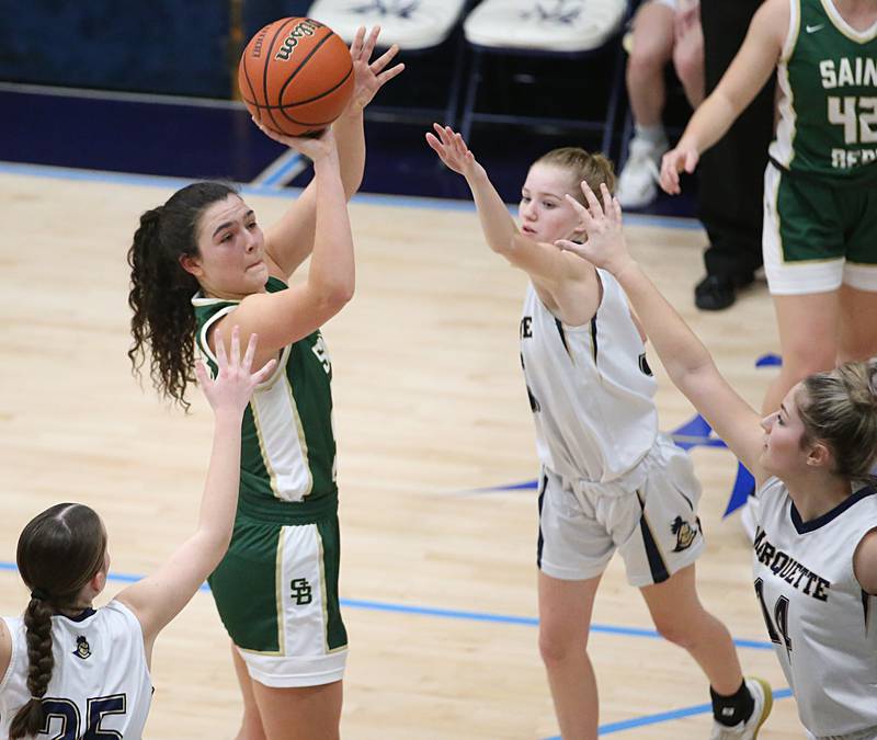 St. Bede's Ali Bosnich pulls up in the lane to score on a shot over Marquette's Chloe Larson, Keely Nelson and Eva McCallum in Bader Gymnasium on Wednesday, Feb. 8, 2022 at Marquette High School.