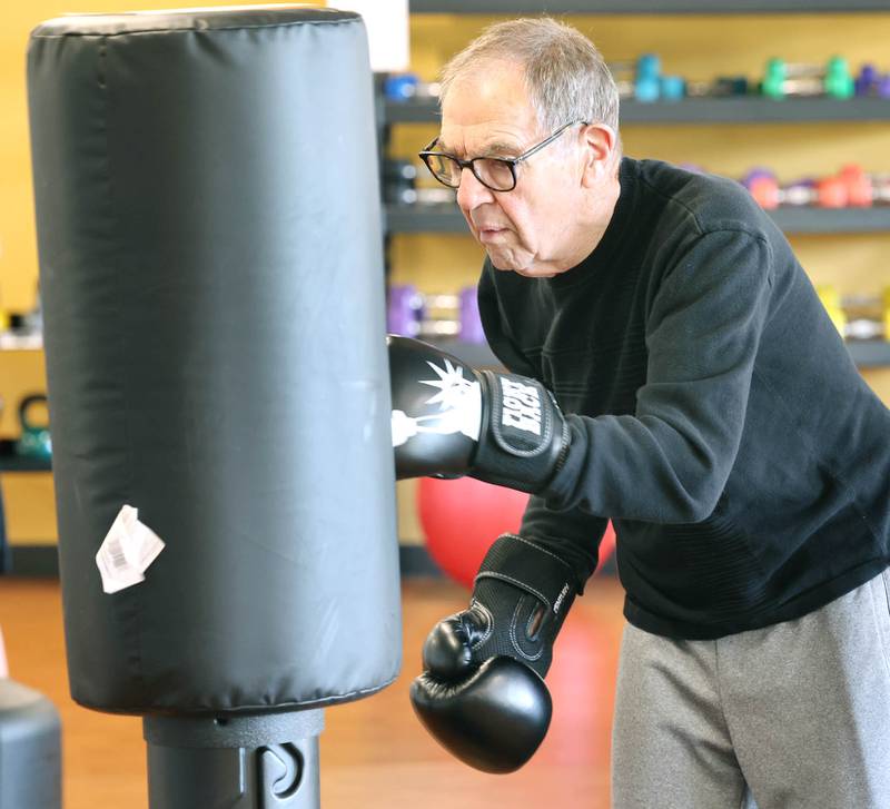 Peter Schram hits the bag Friday, April 28, 2023, during Rock Steady Boxing for Parkinson's Disease class at Northwestern Medicine Kishwaukee Health & Wellness Center in DeKalb. The class helps people with Parkinson’s Disease maintain their strength, agility and balance.