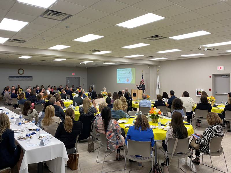 The crowd watches and listens as Village President Ric Offerman shares a recap of Minooka's 2022 on Thursday.