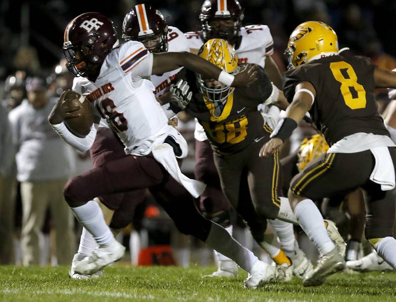 Brother Rice's Marcus Brown, left, runs away from the pursuit of Jacobs' Anthony Barred, center , and Juan Perez, right, during a IHSA Class 7A first round playoff football game Friday, Oct. 28, 2022, between Jacobs and Brother Rice at Jacobs High School in Algonquin.