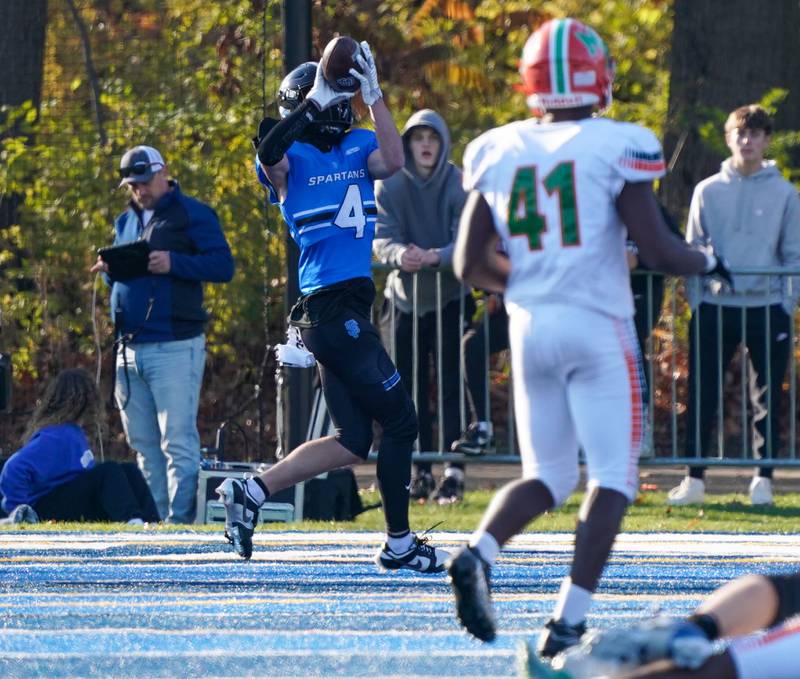 St. Francis' Zach Washington (4) catches a pass for a touchdown against Morgan Park during a class 5A state quarterfinal football game at St. Francis High School in Wheaton on Saturday, Nov 11, 2023.