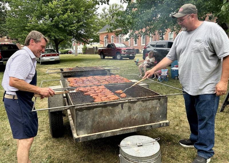 Rick Nelson and Eric Bocker grill pork chops for the Ogle County Pork Producers at the Let Freedom Ring festival in Mt. Morris on Saturday, July 5, 2025.