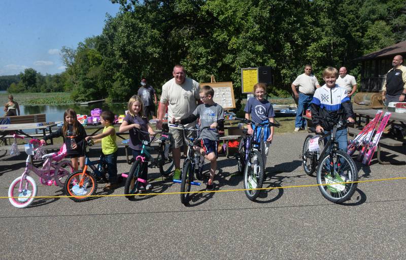 Whiteside County Sheriff John Booker stands with the grand prize winners at this year's  annual fishing derby at Morrison-Rockwood State Park in Morrison on Saturday, Sept. 9, 2023. Pictured, left to right, are: Emmy Sodaro, 5, of Rock Falls; Easton Morine, 4 of Albany; Gracelyn Hanson, 6, of Rock Falls; Avery Holcomb, 9, of Sterlng; Cara Tack, 12, of Fulton; and Mason Kellerman, 12, of Sterling.