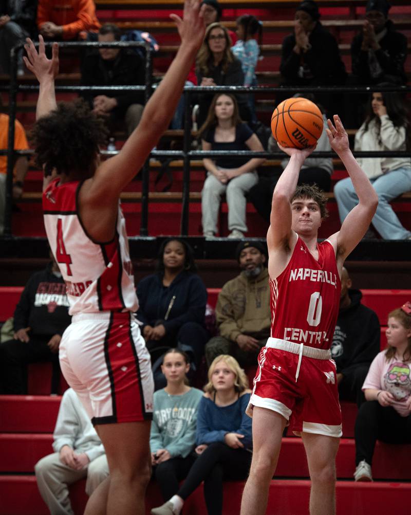 Naperville Central's Quinn Oeth puts up a shot as Bradley-Bourbonnais's DaJuan Brown guards in a game  on Monday, December 15, 2025.